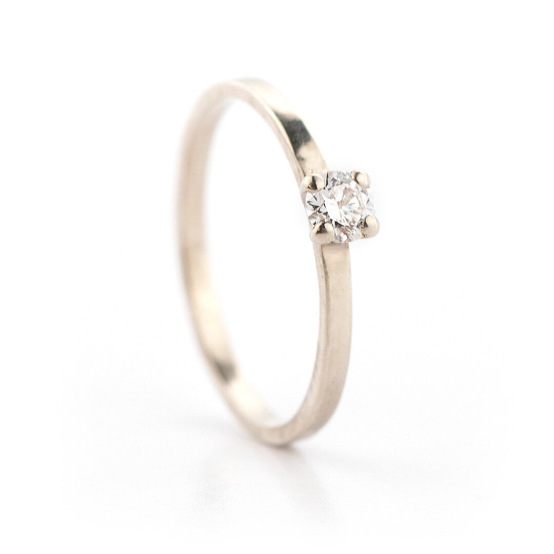 Een witgouden verlovingsring met één diamant, van opzij